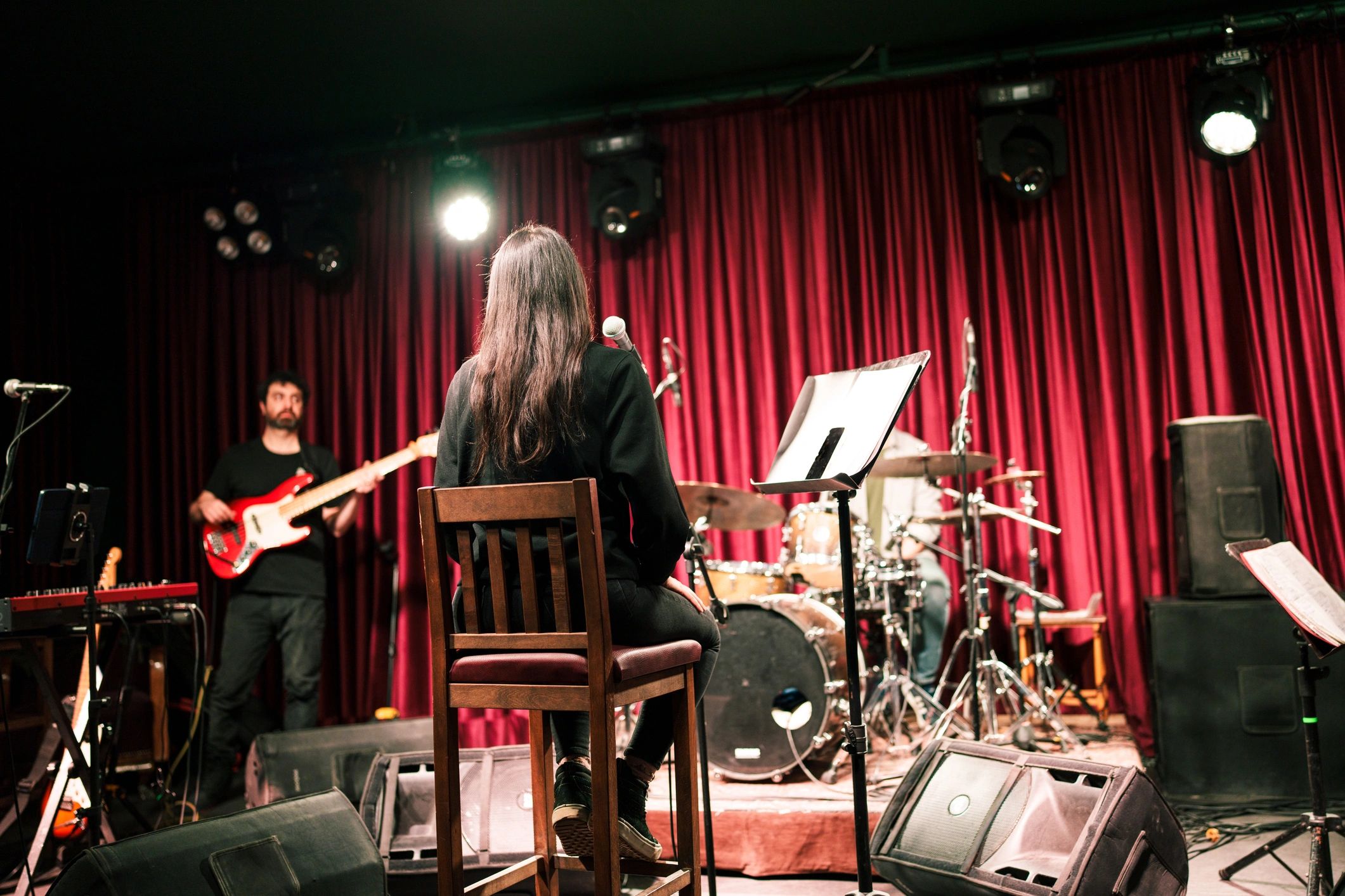 Band rehearsal scene from behind the vocalist