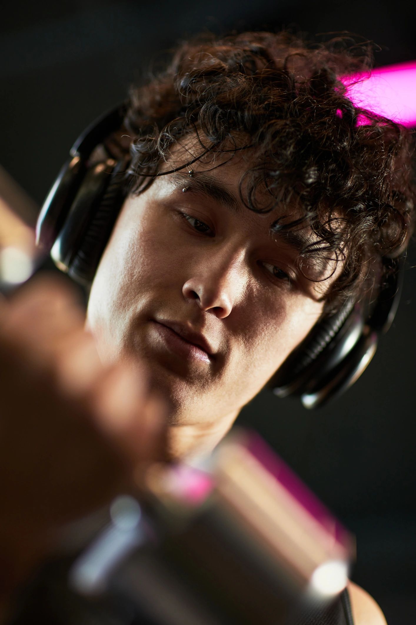 Artist portrait with headphones in a studio setting